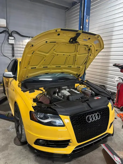 Yellow Audi S4 with hood open receiving maintenance at Chapman Automotive & Synthetics in Troy, MO